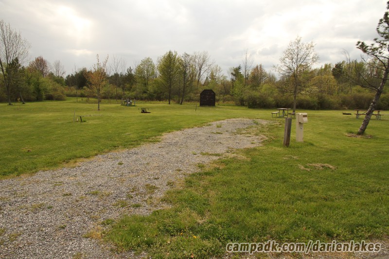 Campsite Photo of Site 114 at Darien Lakes State Park, New York - Looking at Site from Road Sign Visible