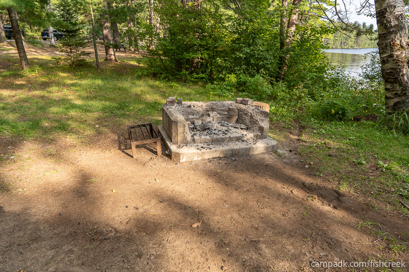 Campsite Photo of Site 46 at Fish Creek Pond Campground, New York - Fireplace View