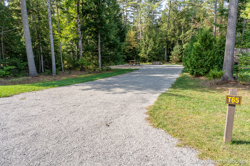 Campsite Photo of Site T65 at Frontier Town Campground, New York - Looking at Site from Road Sign Visible