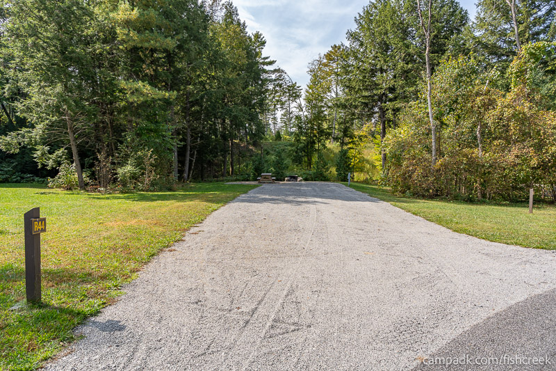 Campsite Photo of Site R44 at Frontier Town Campground, New York - Looking at Site from Road Sign Visible