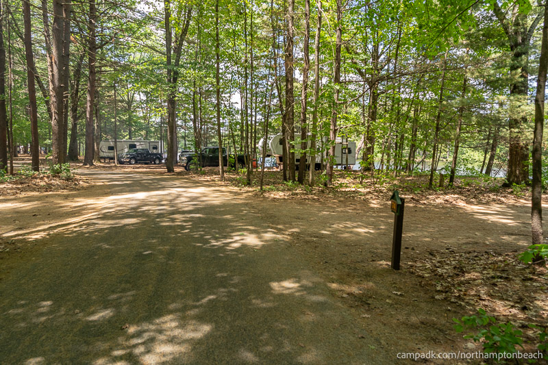 Campsite Photo of Site 74 at Northampton Beach Campground, New York - View Down Road from Campsite