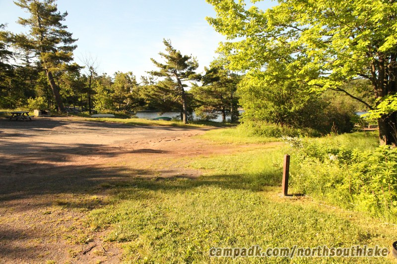 Campsite Photo of Site 150 at North South Lake Campground, New York - Looking at Site from Road Sign Visible