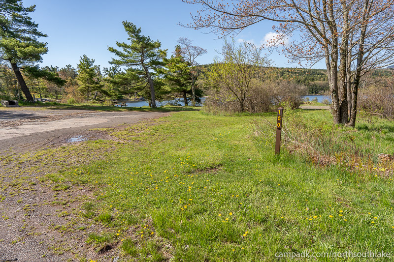 Campsite Photo of Site 150 at North South Lake Campground, New York - Looking at Site from Road Sign Visible