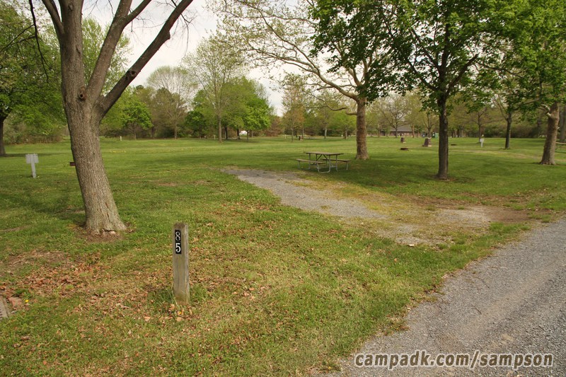 Campsite Photo of Site 85 at Sampson State Park, New York - Looking at Site from Road Sign Visible