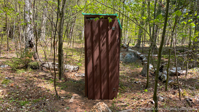 Campsite Photo of Site 65 at Saranac Lake Islands Campground, New York - Outhouse
